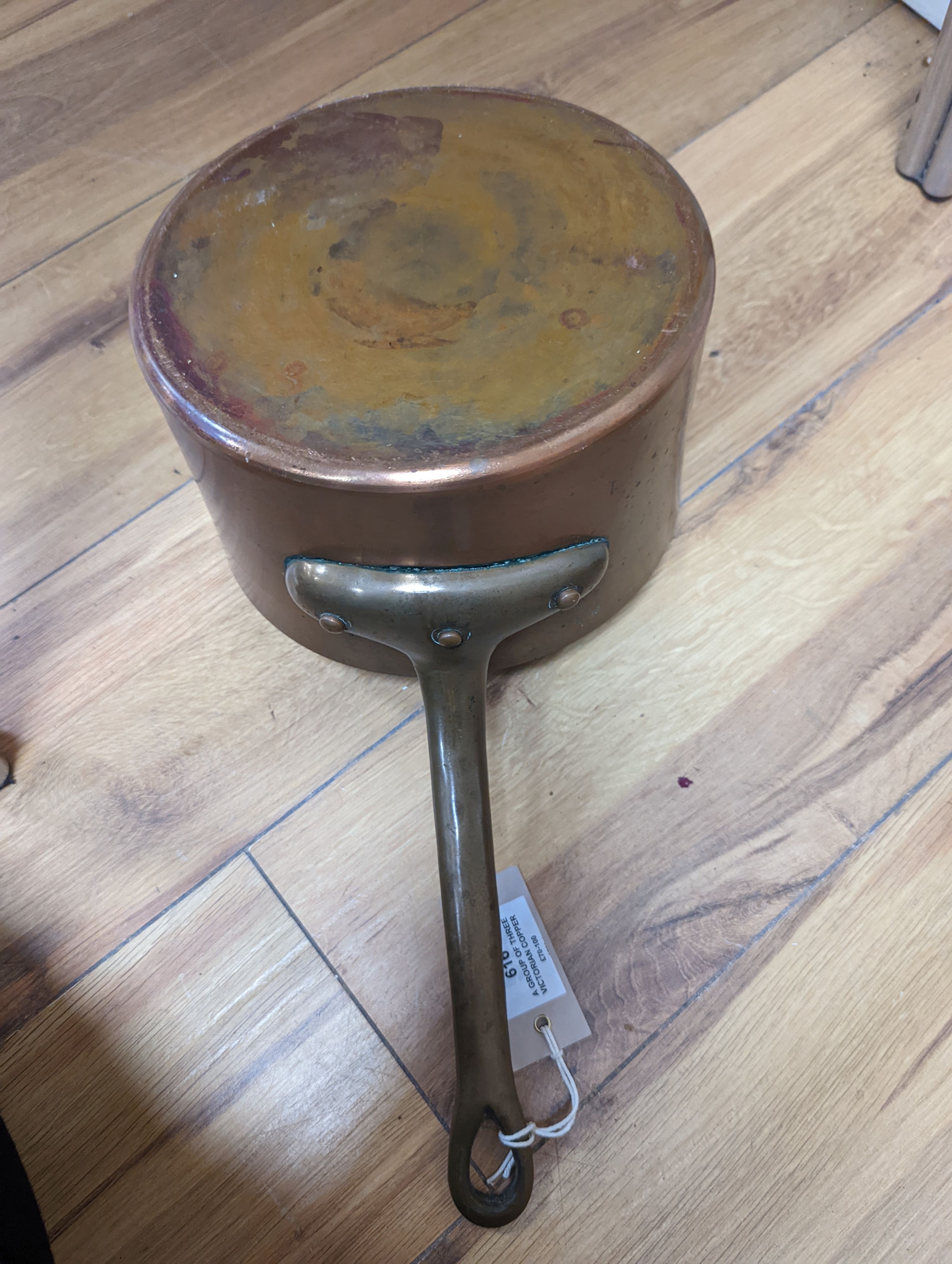 A group of three Jaeggi & Sons copper saucepans